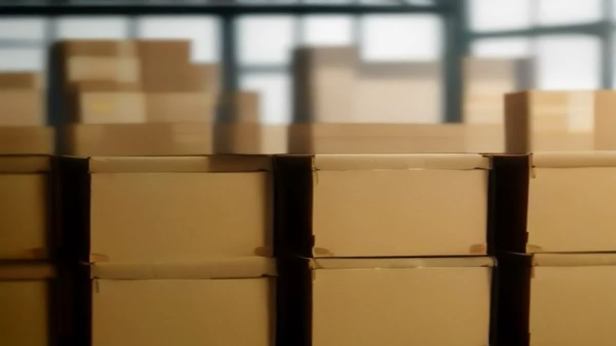 shallow depth of field close-up of a modern warehouse aisle with neatly stacked cartons and a clipboard on a pallet, overcast diffused light